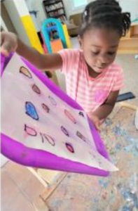 Loving teacher guiding toddlers in Montessori classroom