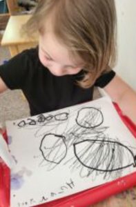 Loving teacher guiding toddlers in Montessori classroom
