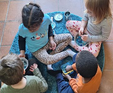 Kids engaged in play-based preschool programs with teachers